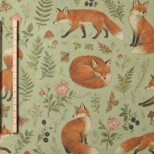 May include: A sage green fabric featuring a repeating pattern of orange foxes in various poses, including walking, sitting, and sleeping, interspersed with illustrations of ferns, mushrooms, blackberries, and moths, with a 25 cm ruler visible.