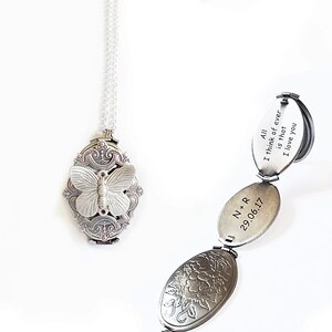 Puede incluir: Collar con un medall&oacute;n de plata con un dise&ntilde;o de mariposa. El medall&oacute;n se abre para revelar tres compartimentos con mensajes grabados: "All I think of ever is that I love you", "N*R 29.06.17", y un dise&ntilde;o floral.