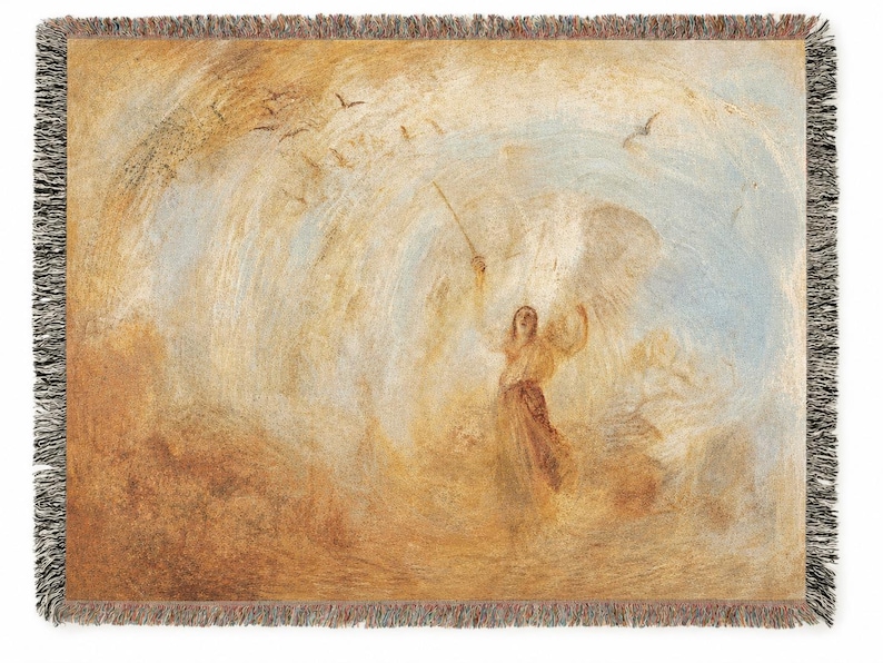 May include: A woven throw blanket featuring a classical painting of an angel with outstretched arms, holding a staff. The artwork is in shades of beige, brown, and blue, with a black fringe border.