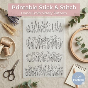 May include: A printable hand embroidery pattern featuring four floral designs. The designs include stylized illustrations of lavender, tulips, poppies, and other wildflowers. The text "Printable Stick & Stitch Hand Embroidery Pattern" is at the top. A pencil and notepad are in the lower right.