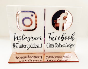 May include: White acrylic sign with a rose gold Instagram and Facebook logo. The sign has the text "Instagram @Glittergoddess14" and "Facebook Glitter Goddess Designs".