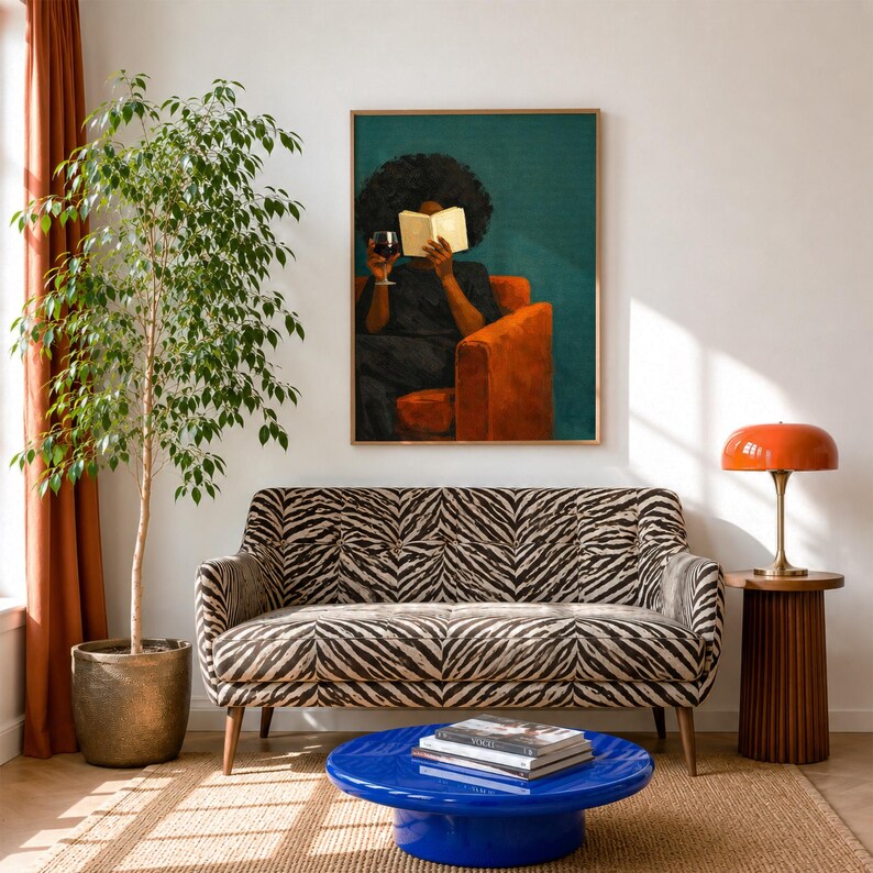 May include: A living room scene featuring a zebra-print sofa, a glossy blue round coffee table with stacked books, a tall potted ficus tree, and an orange mushroom-style lamp on a fluted side table. A framed painting hangs above the sofa.