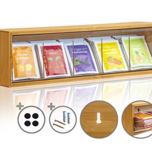 Könnte beinhalten: Rechteckige Teebox aus Bambus mit transparenter Front, die Teebeutel mit verschiedenen Fruchtaromen enthält. Aromen: Pfirsich und Zitrone, Kirsche, schwarze Johannisbeere, Erdbeere und Mango, Ananas und Birne. Inklusive Montagematerial.