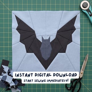 May include: A square, light blue fabric block with a black bat design, created using the paper piecing technique. The bat has outstretched wings and a detailed body. The text "INSTANT DIGITAL DOWNLOAD START SEWING IMMEDIATELY!" is displayed at the bottom.