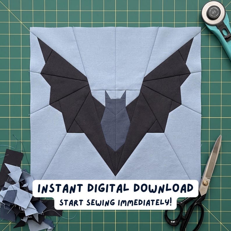May include: A square, light blue fabric block with a black bat design, created using the paper piecing technique. The bat has outstretched wings and a detailed body. The text "INSTANT DIGITAL DOWNLOAD START SEWING IMMEDIATELY!" is displayed at the bottom.