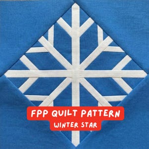 May include: A blue and white quilt block featuring a snowflake design. The snowflake is made of white fabric and is set against a blue background. The text "FPP QUILT PATTERN WINTER STAR" is displayed in a red rectangle.