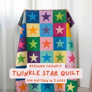 May include: A colorful quilt with a patchwork design featuring large star shapes in various colors, including blue, green, orange, and pink. The quilt has the text "Twinkle Star Quilt" and "Beginner Friendly" on it.