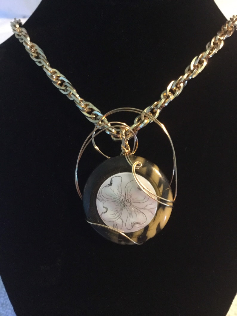 Dogwood scrimshaw on mother-of-pearl with vintage button back GF wire