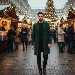 May include: A man wearing a dark green overcoat, black pants, and brown boots walks toward the viewer. The background shows a Christmas market with festive lights and a decorated Christmas tree. Snow is falling.