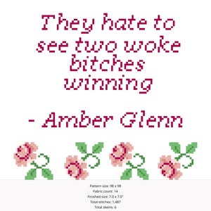Puede incluir: Diseño de punto de cruz con el texto "They hate to see two woke bitches winning" atribuido a Amber Glenn. El diseño presenta rosas rosas pixeladas y hojas verdes en el borde inferior, sobre un fondo blanco.