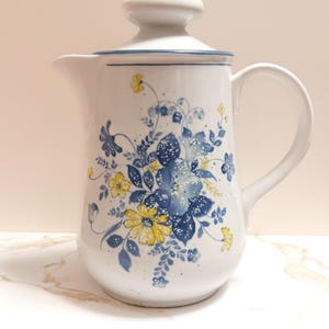 May include: A handmade wooden sign with the text "Welcome to our home" in a handwritten style. The sign is painted white with black lettering and a distressed finish, perfect for farmhouse decor.