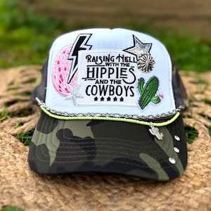 Raising Hell Hippies Cowboys Trucker Hat | Camo Brim Boho Country Cap