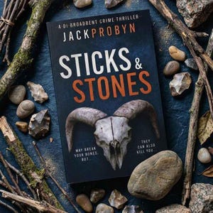 Può includere: Copertina del libro "STICKS & STONES" di Jack Probyn, un thriller poliziesco. Presenta un teschio di ariete, il titolo in bianco e arancione e il testo "MAY BREAK YOUR BONES. BUT... THEY CAN ALSO KILL YOU..." su sfondo blu scuro.