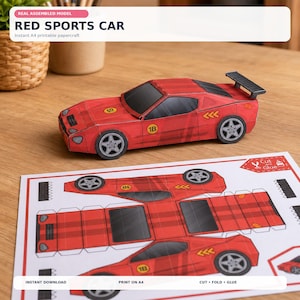 Könnte beinhalten: Ein Papiermodell eines roten Sportwagens mit schwarzen Fenstern und einem Heckspoiler, verziert mit gelben 1B-Aufklebern und orangefarbenen Pfeilgrafiken. Darunter liegt ein flacher A4-Bogen mit den zum Ausschneiden und Kleben gedruckten Teilen.
