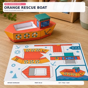 May include: An orange rescue boat papercraft model with a teal cabin and life ring graphics, displayed alongside a flat A4 printable sheet featuring the boat's cut-out components, anchor icons, and assembly instructions labeled Cut and Glue.
