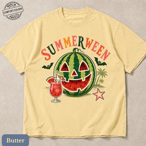 May include: A butter-yellow short-sleeve t-shirt featuring a graphic of a watermelon carved like a jack-o'-lantern. The text reads SUMMERWEEN above the melon, which is accompanied by a tropical drink, palm trees, bats, and a star.