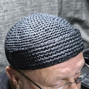 May include: A white ceramic mug with a black handle and the text "But First, Coffee" in a black, bold font. The mug is on a white surface.