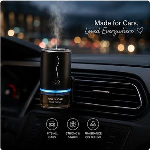 May include: Black car air freshener with a blue illuminated base, emitting a vapor. The product is labeled "PINK SUGAR EAU DE PARFUM". Text reads "Made for Cars. Loved Everywhere." and icons indicate it fits all cars, is strong & stable, and offers fragrance on the go.