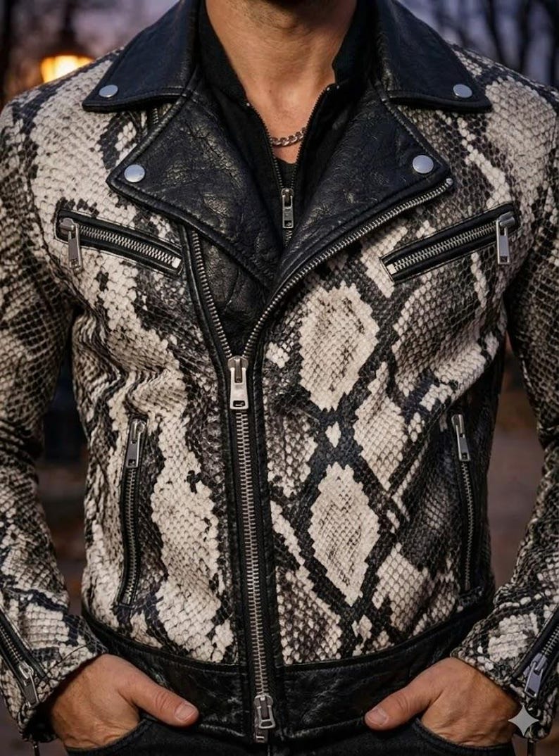 May include: A black and white snakeskin-patterned leather jacket with a black leather collar and lapels. The jacket has multiple silver zippers and a classic biker jacket design.