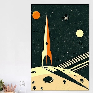 May include: A vertical wall art print featuring a stylized orange and yellow rocket ship standing on a cratered moon surface. The dark space background includes a bright orange planet, a pale yellow moon, and a white star against a starry sky.