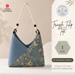 May include: A triangle-shaped tote bag featuring a solid blue panel and a floral patterned panel with blue and cream roses. The bag has a twisted white rope handle attached with dark wooden rings and black beads. Text reads Tringle Tulip Tote.