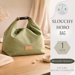 May include: A sage green slouchy hobo bag with a black buckle closure. The bag has a small, rectangular patch with a heart design. Text on the image reads "Slouchy Hobo Bag", "1 Size", "Beginner Friendly", and "Pattern Instant Download".
