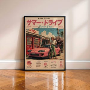 Könnte beinhalten: Ein gerahmtes Poster mit einem rosa Sportwagen, der vor roten Verkaufsautomaten geparkt ist. Eine Person steht neben dem Auto. Der Text lautet Summer Drive auf Englisch und Japanisch, ergänzt durch technische Spezifikationen und grafische Symbole.