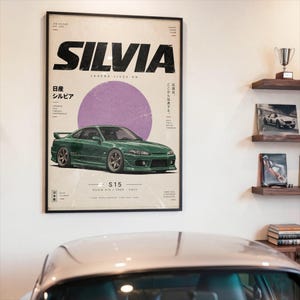 May include: A framed poster featuring a green Nissan Silvia S15 sports car centered below a large purple circle. The text reads SILVIA, LEGEND LIVES ON, S15, SILVIA S15 1999-2002, and includes Japanese characters and additional technical design details.