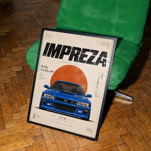 Könnte beinhalten: Ein gerahmtes Poster mit einem blauen Subaru Impreza 22B Auto, zentriert unter einem großen orangefarbenen Kreis. Der Text lautet IMPREZA, LEGEND LIVES ON, 22B und enthält japanische Schriftzeichen. Das Design hat eine gealterte Textur auf cremefarbenem Grund.