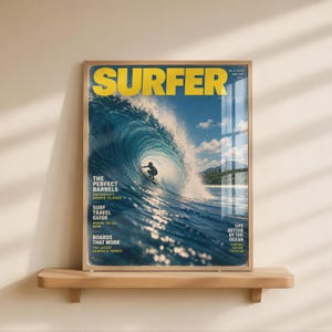 May include: A framed magazine cover titled SURFER from June 1970, featuring a large blue ocean wave with a surfer riding inside the barrel. The text includes THE PERFECT BARRELS, SURF TRAVEL GUIDE, BOARDS THAT WORK, and LIFE BETTER BY THE OCEAN.