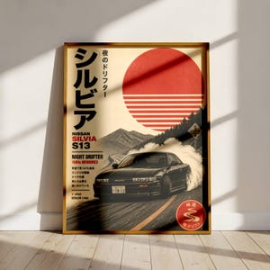 May include: A vertical poster featuring a black Nissan Silvia S13 drifting on a mountain road. The design includes a large red sun graphic, Japanese text, and the words Nissan Silvia S13 Night Drifter 1980s Memories. The scene depicts tire smoke.