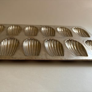 Vintage, French Madeleine shell-shaped bakeware pan, made of strong tinned steel and stamped “made in France” on the back