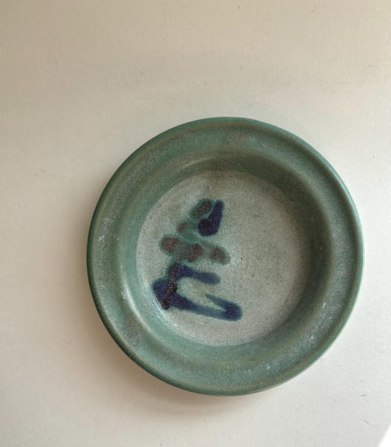 A signed, one-of-a-kind handmade studio ceramic trinket dish with vintage Asian aesthetic — the kind of small object that quietly anchors a desk or nightstand with real character.