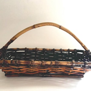 Dark bamboo and wicker vintage rectangular basket, for decorative display or storage with woven wicker/bamboo handle and aged patina.