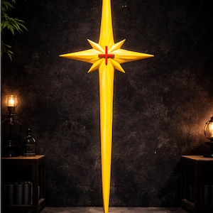 May include: A tall, yellow star-shaped sculpture with a red cross in the center. The sculpture is mounted on a black circular base. The star has eight points and is set against a dark background.