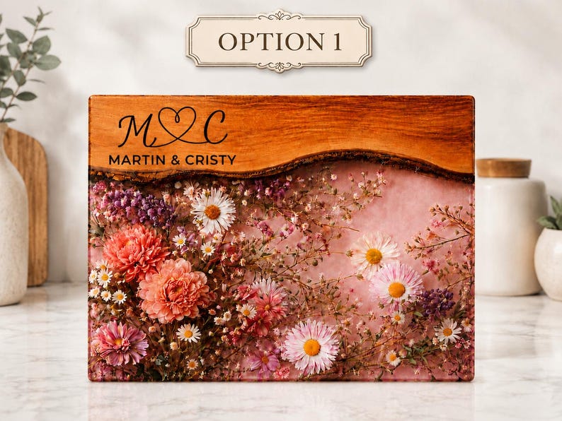 May include: A rectangular wooden plaque with a live edge, featuring embedded flowers in shades of pink, white, and purple. The top section has the text "OPTION 1" and the names "MARTIN & CRISTY" with initials "M & C" in a heart.