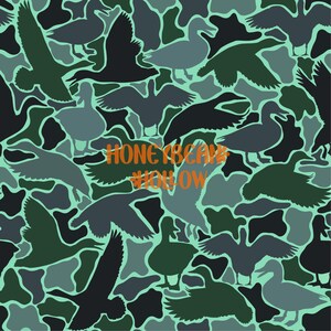 May include: A repeating pattern fabric featuring silhouettes of ducks in various poses, rendered in shades of dark green, charcoal grey, and light blue-grey. The text HONEYBEAN HOLLOW is printed in a bold, orange, rounded font across the centre.