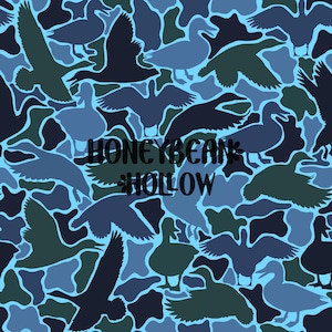 May include: A seamless pattern featuring silhouettes of ducks in various poses, including flying and standing, rendered in shades of dark blue, navy, and light blue. The text HONEYBEAN HOLLOW is centered in black, bold, sans-serif capital letters.