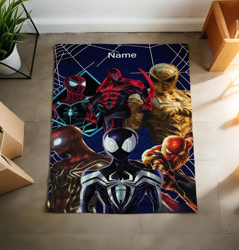 May include: A rectangular blanket featuring a dark blue background with a white spiderweb pattern and the word Name printed at the top. The design displays six different Spider-Man characters in various red, black, gold, and blue suits.