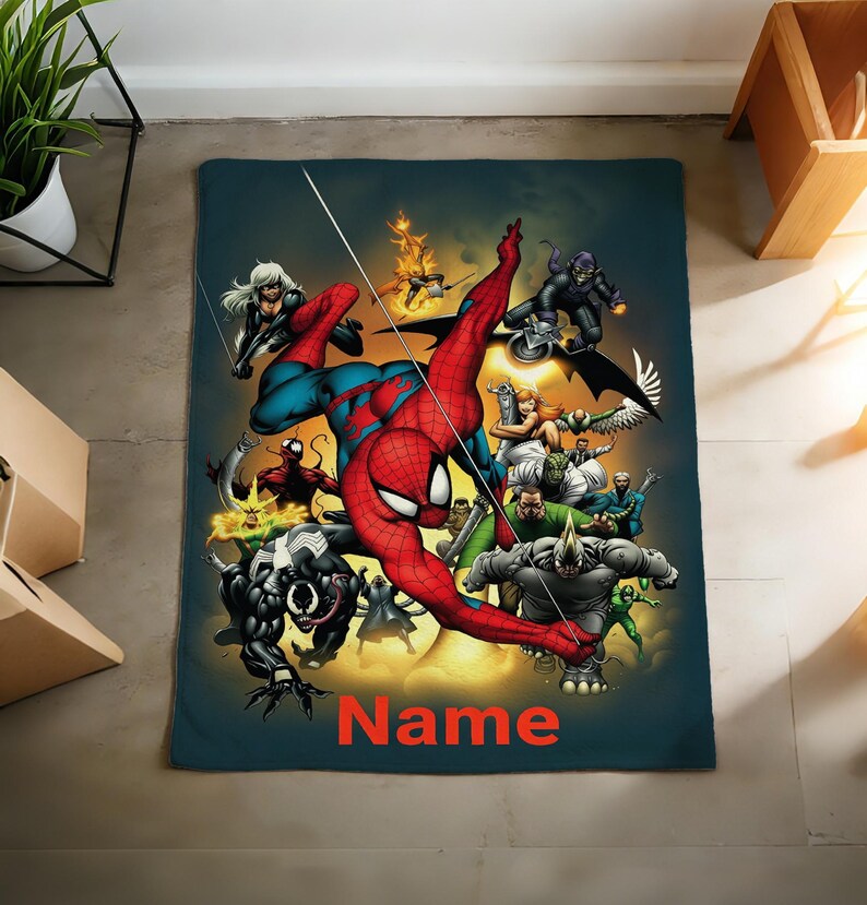 May include: A rectangular throw blanket featuring a vibrant graphic illustration of Spider-Man surrounded by various comic book villains including Venom, Carnage, and Rhino. The word Name is printed in bold orange letters at the bottom center.