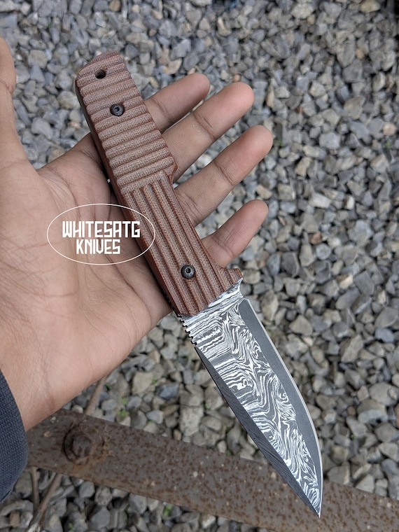 San-Mai Damascus layering means the blade literally has visible geology — a hand-forged EDC knife with Micarta scales that looks like a museum piece but lives in your pocket.