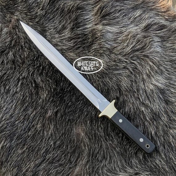 A hand-forged D2 tool steel toothpick knife with Micarta handle — a tiny, obsessively-crafted EDC piece that straddles the line between functional tool and miniature art object.
