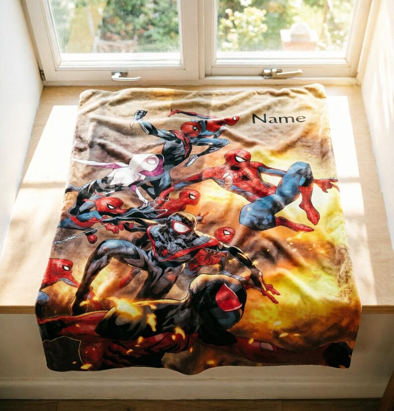 May include: A rectangular fleece blanket featuring a vibrant, multi-character Spider-Man graphic with various versions of the hero in action poses against a warm, golden-yellow background. The word Name is printed in black in the upper right corner.