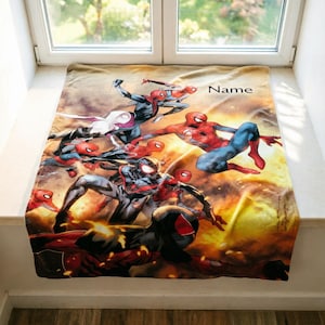 May include: A rectangular fleece blanket featuring a vibrant, multi-character graphic of various Spider-Man figures in dynamic action poses against a fiery orange and yellow background. The word Name is printed in black in the upper right corner.
