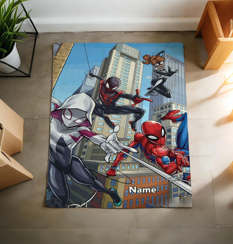 May include: A rectangular blanket featuring a colorful comic book style illustration of four superheroes in action against a city skyline. The design includes characters in red, blue, black, and white suits, with the word Name printed in white text.
