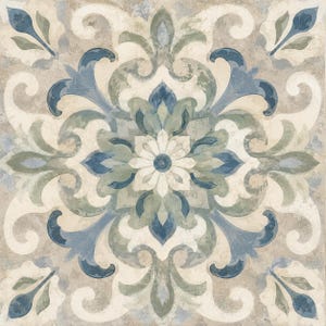 May include: A square decorative tile featuring a symmetrical floral pattern in shades of blue, sage green, and cream. The design includes intricate scrollwork and a central flower motif with a weathered, matte finish across the entire surface.