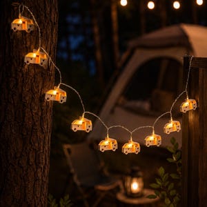 Eine Lichterkette mit kleinen, weißen, Van/Kastenwagen-Motiven. Jeder Van hat ein herzförmiges Ausschnittdetail und strahlt ein warmweißes Licht aus. Die Lichter sind durch einen dünnen, flexiblen Draht verbunden.