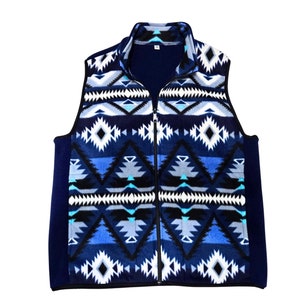 May include: A blue fleece vest with a geometric pattern in shades of blue, white, and black. The vest has a zipper closure.
