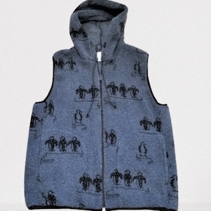May include: A blue hooded vest with a zipper closure and a penguin pattern. The vest is made of a soft, fuzzy material.