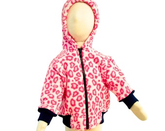 May include: Pink fleece jacket with a leopard print and a black zipper. The jacket has a hood and navy blue cuffs.